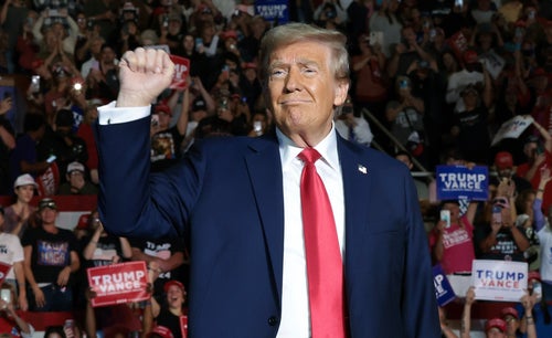 Former President Donald Trump, reacts to supporters as he arrives for a campaign rally at East Carolina University on Oct. 21 in Greenville, North Carolina.