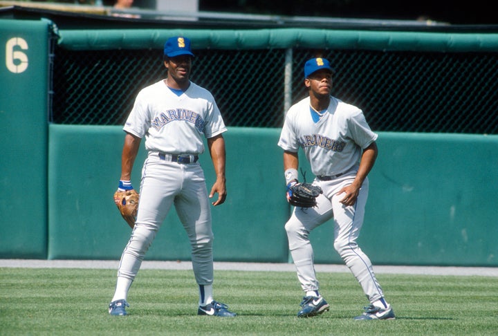 Ken Griffey Sr., left, and Ken Griffey Jr. practice before a Mariners game back in the day. The famous father and son plan to attend the Lakers' season opener.