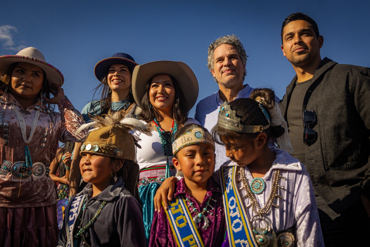 Allie Redhorse Young, an Indigenous activist and founder of Protect the Sacred, stands next to actors Mark Ruffalo, Wilmer Valderrama and Cara Jade Myers before walking to the polls in Fort Defiance, Arizona, on Oct. 12.