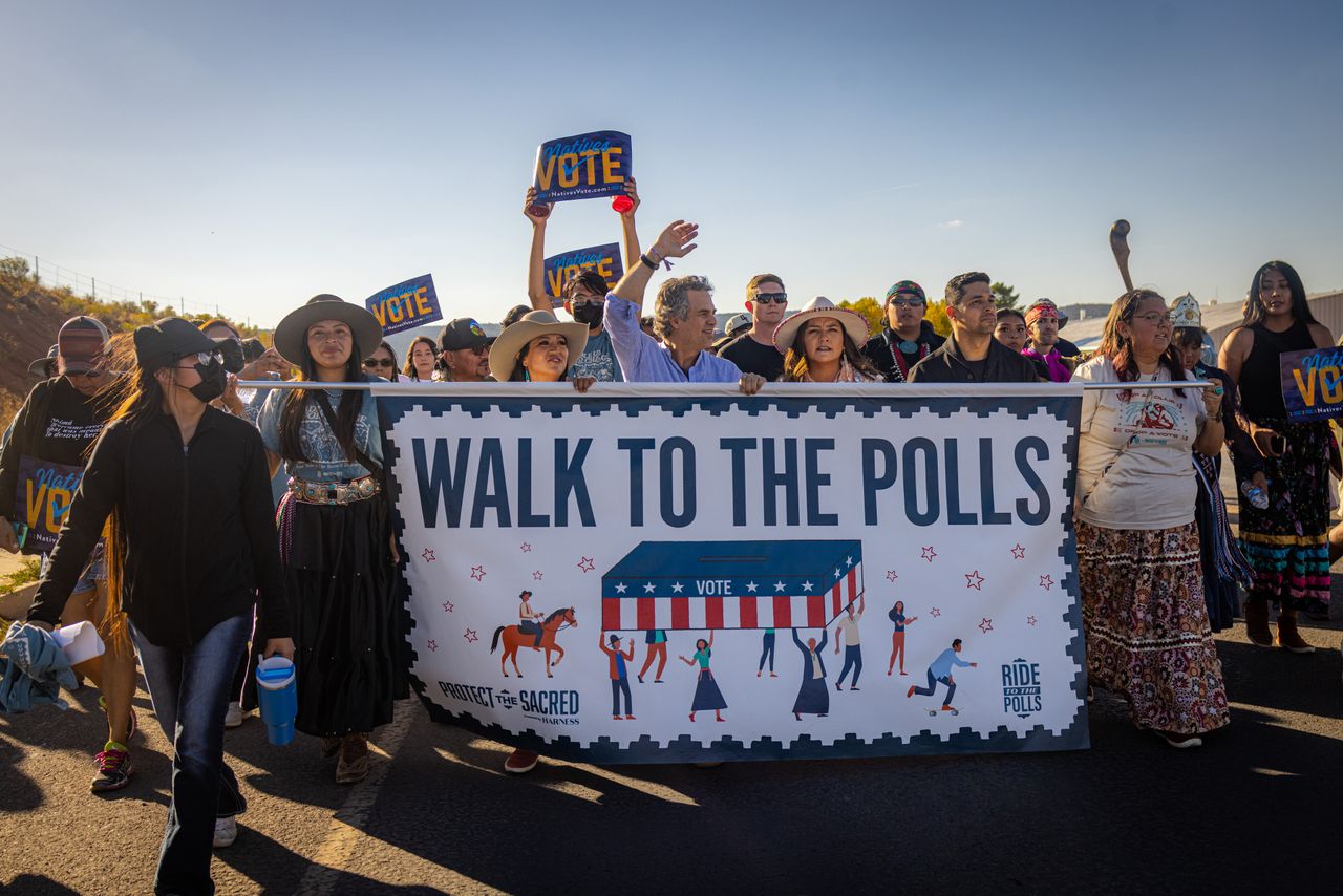 Hundreds of Indigenous voters and allies walk to the polls Saturday afternoon in Fort Defiance, Arizona. 