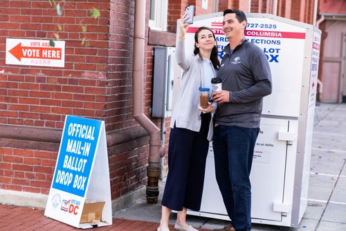 Above, a couple takes a selfie after dropping ballots in a ballot box on November 8, 2022. In Washington D.C., you are allowed to take a selfie of your own ballot.