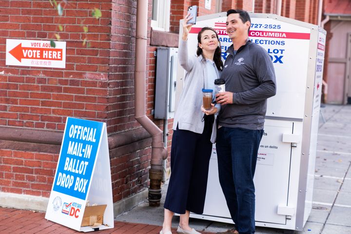 Above, a couple takes a selfie after dropping ballots into a ballot box on November 8, 2022. In Washington DC, you're allowed to take a selfie of your own ballot. 