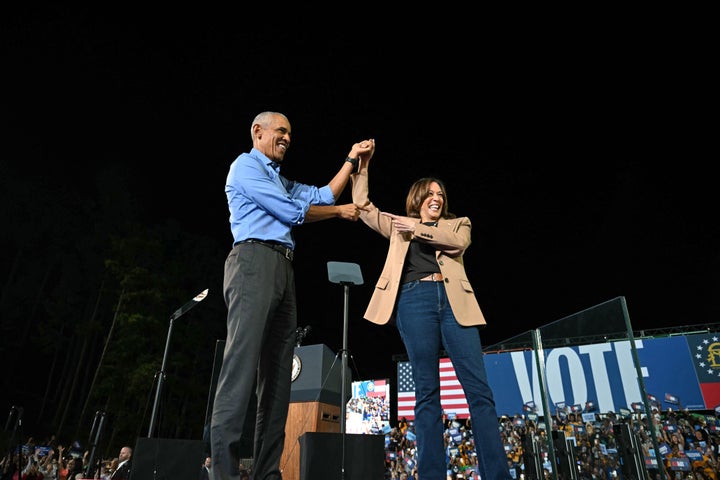 Former President Barack Obama holds hands with Vice President Kamala Harris, the Democratic presidential nominee, at the Atlanta area rally.