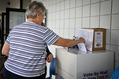 A voter casts a ballot Monday during early voting at a polling station in Deland, Florida.