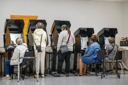 The voting booths were full Tuesday as Kansans turned out for early voting at the Palestine Senior Center in Kansas City, the first day of no-excuse absentee voting.