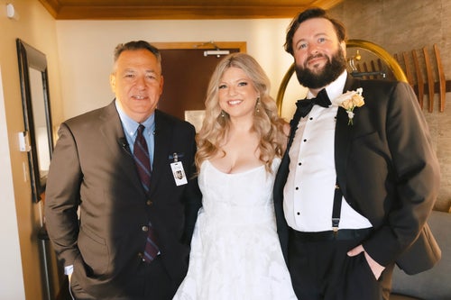 Josh Mankiewicz (left) poses with newlyweds Sara Runnels (middle) and her husband, Adam, after officiating their wedding on Oct. 12, 2024.