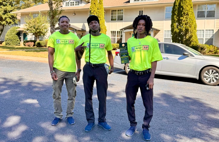 Mudrik McWilliams (left) campaigns with his brothers in Atlanta. “There are tangible differences we can make in our society with our vote." he said.