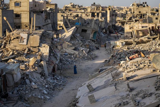 FILE - Palestinians walk through the destruction left by the Israeli air and ground offensive on Khan Younis, Gaza Strip, on Sept. 12, 2024. (AP Photo/Abdel Kareem Hana, File)