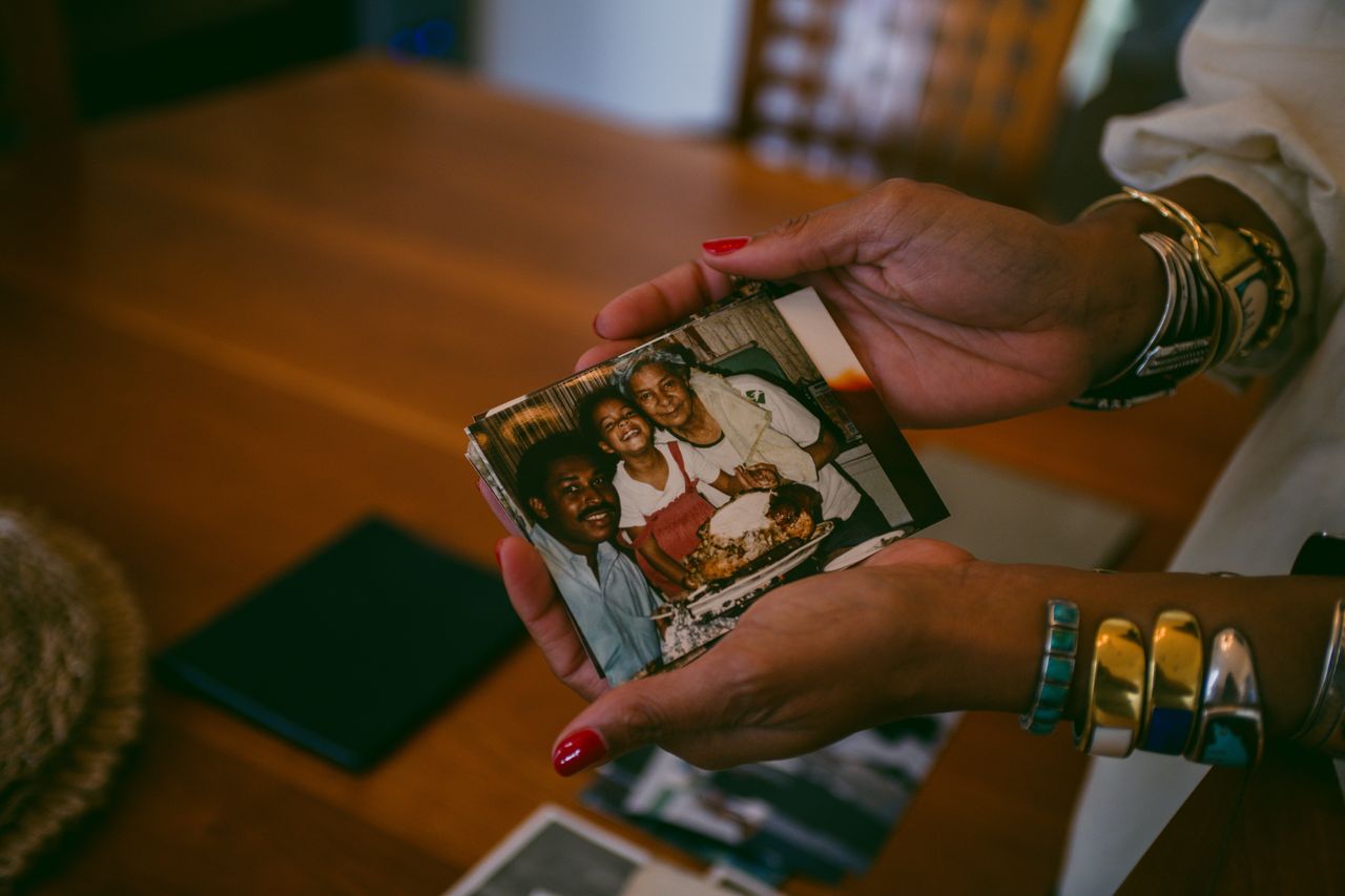 Kay Washington holds a photo of herself as a child with her grandmother, Black Panther leader Doris Price, at home in San Francisco.