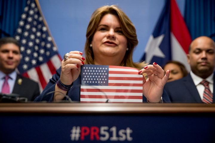 Resident Commissioner Jenniffer González-Colón, who represents Puerto Rico as a nonvoting member of Congress, holds up an American flag with 51 stars as she speaks about Puerto Rico statehood on Oct. 29, 2019, on Capitol Hill.