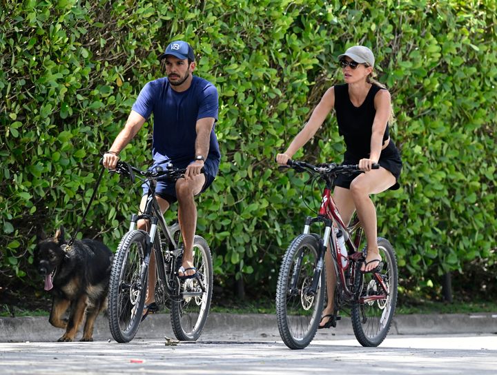 Gisele Bündchen and Joaquim Valente, pictured on a bike ride in July 2024, are reportedly expecting a baby.