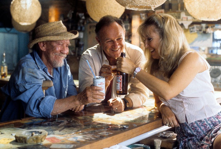 Burgess Meredith, Gene Hackman, and Teri Garr toast each other in a scene from the film 'Full Moon In Blue Water', 1988. (Photo by Trans World Entertainment (TWE)/Getty Images)