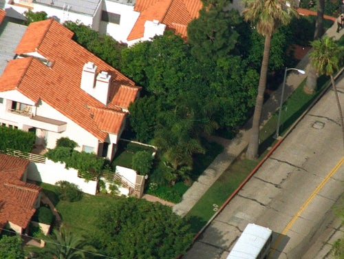 Nicole Brown Simpson's condo, top with two chimneys, during a visit by principals in the O.J. Simpson double-murder trial on Bundy Drive in the Brentwood area of Los Angeles on Feb. 12, 1995.