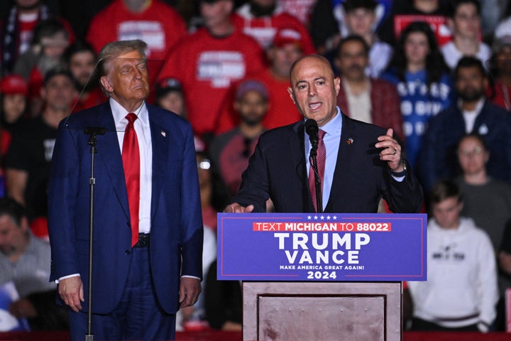 Donald Trump listens as Dearborn Heights, Michigan, Mayor Bill Bazzi speaks on Saturday. Bazzi, an immigrant from south Lebanon, claimed Trump brought "peace."