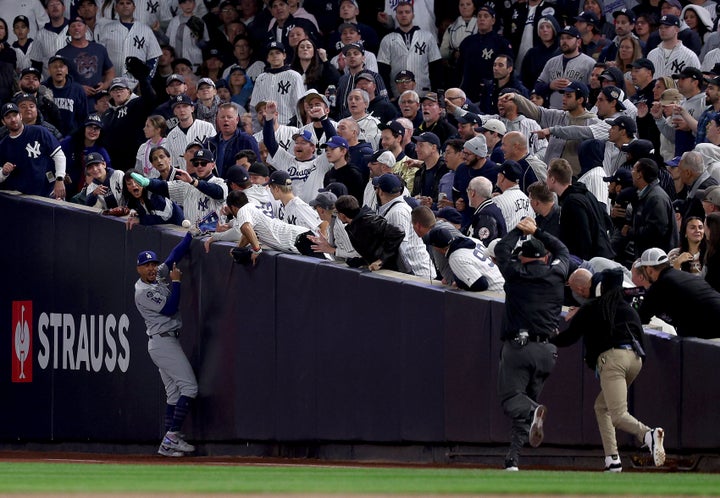 Mookie Betts #50 of the Los Angeles Dodgers reacts after catching a fly ball in foul territory despite fan interference during the first inning of Game Four of the 2024 World Series against the New York Yankees at Yankee Stadium on October 29, 2024 in the Bronx borough of New York City. (Photo by Elsa/Getty Images)