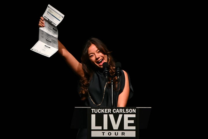 Shanahan holds up her Trump ballot at the "Tucker Carlson Live" event in Arizona on Thursday.