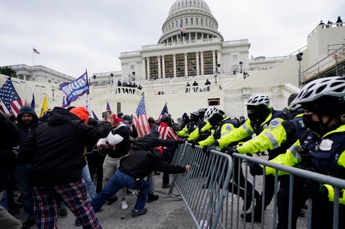 Insurrectionists loyal to President Donald Trump try to break through a police barrier on Jan. 6, 2021, at the U.S. Capitol while both houses of Congress were meeting to certify the electoral vote.