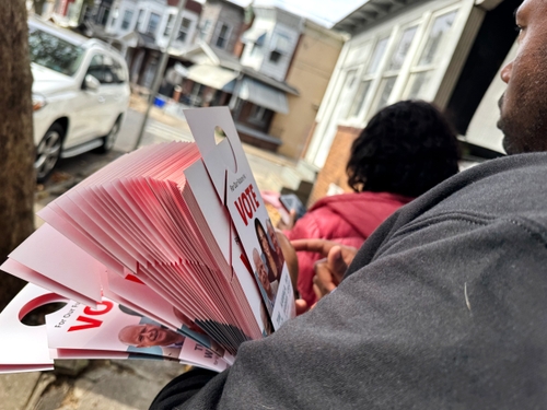 Veronica Bell and Brian Phelps canvass a neighborhood in North Philadelphia in late October. They two of a number of volunteer and paid canvassers allied with Democrats in a key swing state.
