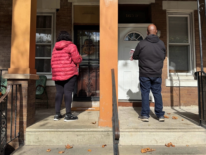 Veronica Bell and Brian Phelps knock on doors in Philadelphia's Hunting Park neighborhood.