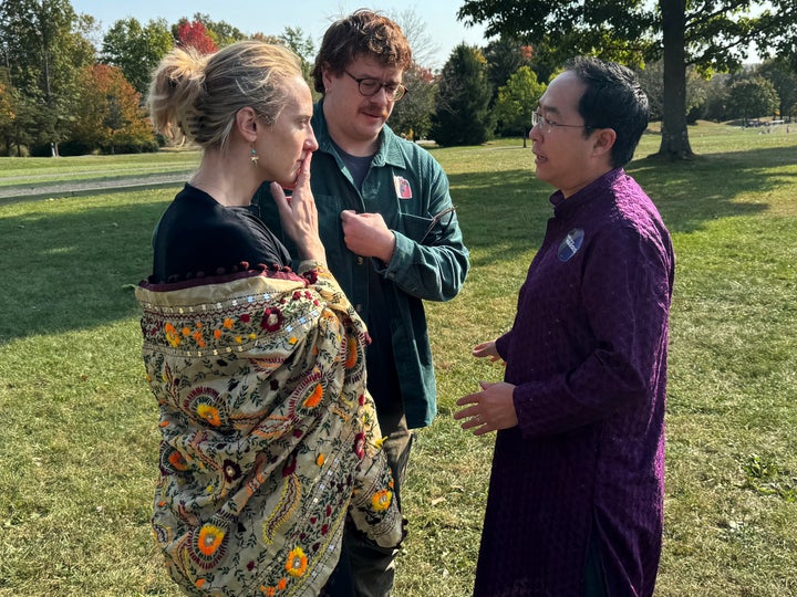 Rep. Andy Kim (D-N.J.), right, confers with Sue Altman, left, the Democratic nominee in New Jersey's 7th Congressional District, as an aide to Altman looks on.