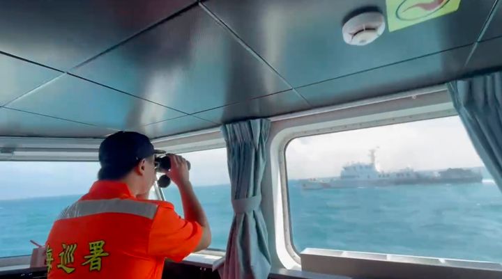 In this screen grab from video released by the Taiwan coast guard, a member of the Taiwan coast guard monitors a China coast guard boat as it passes near the coast of Matsu islands, Taiwan, on Monday, Oct. 14, 2024. 