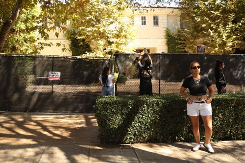 Visitors take photos of the Menendez brothers former mansion on Oct. 23, 2024, in Beverly Hills, California.