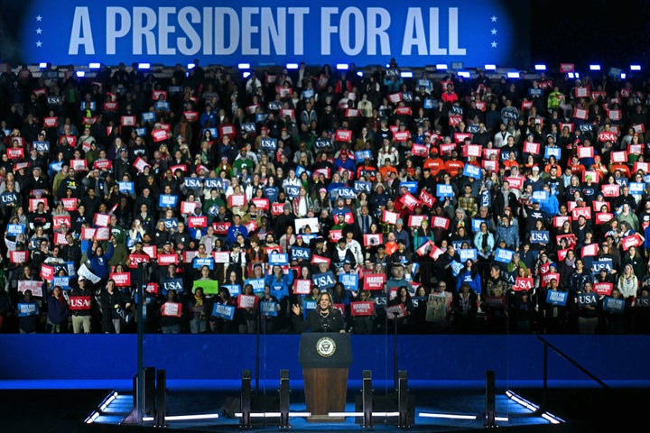 Harris spoke in front of a crowd holding red, white and blue placards, and a sign that said "A president for all."