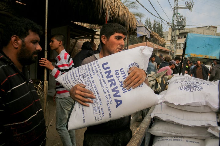 A man clutches a large sack of flour labeled UNRWA during distribution efforts in Deir al-Balah, Gaza, on Nov. 2, 2024. The Turkish Disaster and Emergency Management Presidency (AFAD) has provided flour amid a food crisis caused by ongoing Israeli attacks.