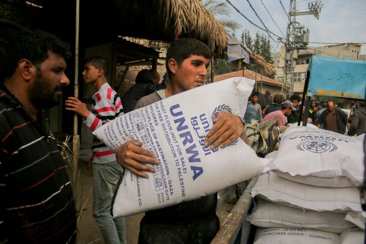 A man clutches a large sack of flour labeled UNRWA during distribution efforts in Deir al-Balah, Gaza, on Nov. 2, 2024. The Turkish Disaster and Emergency Management Presidency (AFAD) has provided flour amid a food crisis caused by ongoing Israeli attacks. 