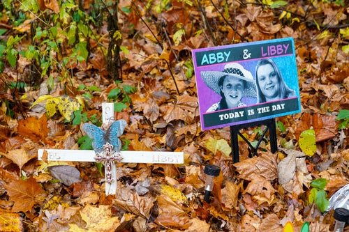 A makeshift memorial to Libby German and Abby Williams, near where they were last seen and where their bodies were discovered, stands on Oct. 31, 2022, along the Monon Trail leading to the Monon High Bridge Trail in Delphi, Indiana.