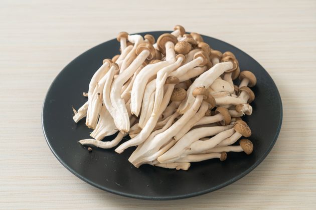 fresh brown beech mushroom or black reishi mushroom on plate