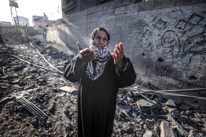 A Palestinian woman watches search and rescue efforts in the rubble after Israeli forces attacked the Nuseirat refugee camp in central Gaza on Nov. 7, 2024.