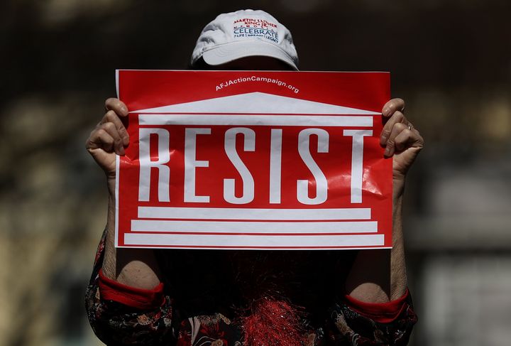 A protester holds a sign during a march and rally to support women's health programs and protest the White House's so-called global gag rule on March 8, 2017, in Washington.