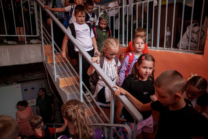 Children from Gymnasium No. 6 head to a basement set up with classrooms during an air alert in Zaporizhzhia, Ukraine, Sept. 3. The city is building a dozen subterranean schools designed to be radiation- and bomb-proof. 