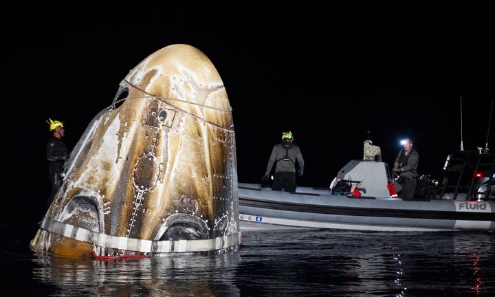 This photo provided by NASA shows support teams work around the SpaceX Dragon Endeavour spacecraft shortly after it landed, in the Gulf of Mexico off the coast of Pensacola, Florida, Friday, Oct. 25, 2024. (NASA/Joel Kowsky via AP)