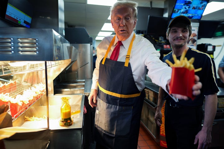 Donald Trump works behind the counter making french fries during a campaign event at McDonald's restaurant on October 20, 2024 in Feasterville-Trevose, Pennsylvania. (Photo by Doug Mills-Pool/Getty Images)