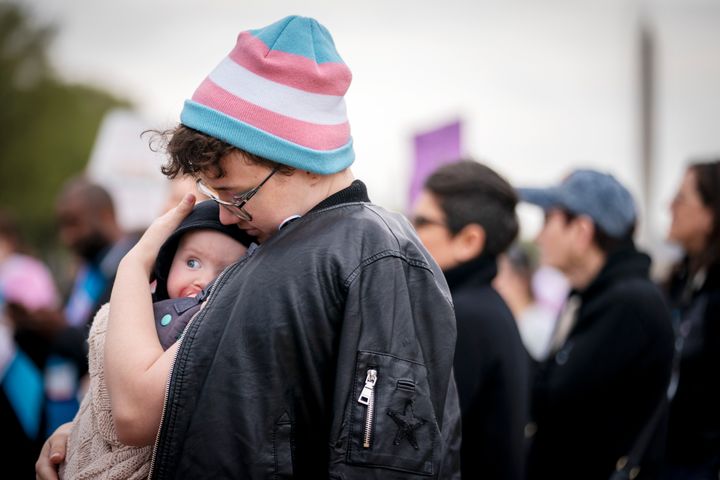 FILE - Zach Norris holds his baby Adelaide, 7 months, while attending a rally as part of Transgender Day of Visibility on March 31, 2023, near the Capitol in Washington. (AP Photo/Jacquelyn Martin, File)