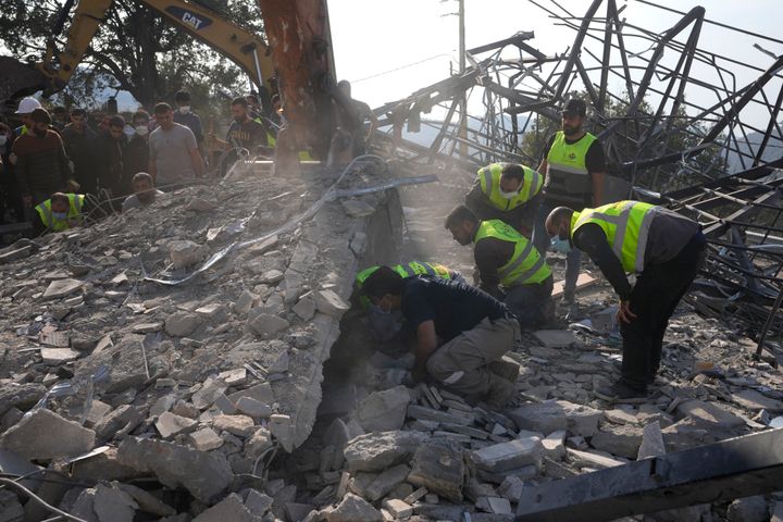 Rescue workers search for victims under the rubble of a destroyed house hit in an Israeli airstrike, in Aalmat village, northern Lebanon, on Nov. 10, 2024.