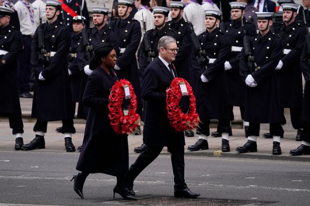 Britain's Prime Minister Keri Starmer, right and Conservative Party leader Kemi Badenoch carry wreaths as they take part in the Remembrance Sunday service at the Cenotaph in London, Sunday, Nov. 10, 2024.