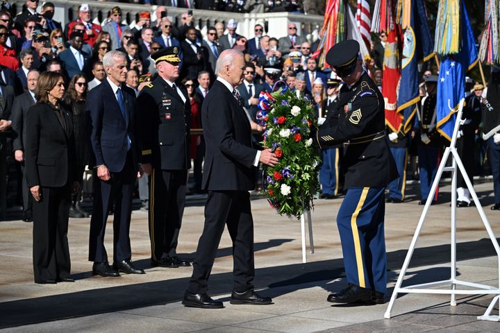 President Joe Biden lays a wreath at The Tomb of the Unknown Soldier at Arlington National Cemetery to mark Veterans' Day as Vice President Kamala Harris and Veterans' Affairs Secretary Denis McDonough look on.