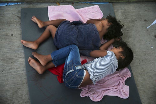 Migrant children sleep on a mattress on the floor of the AMAR migrant shelter in Nuevo Laredo, Mexico, on July 17, 2019.