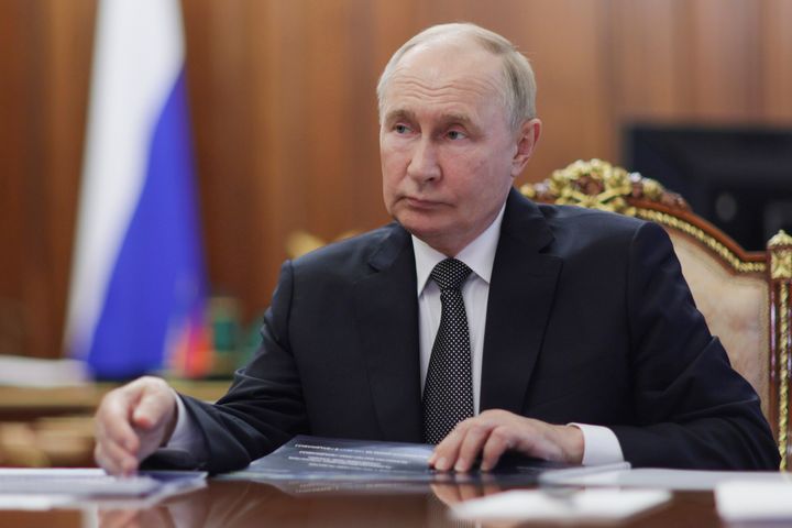 Russian President Vladimir Putin listens to head of the Republic of North Ossetia-Alania Sergei Menyailo during their meeting in Moscow, Russia, Monday, Nov. 11, 2024. 