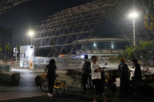 People gather near a sports center after a man rammed a car into people exercising at the center in Zhuhai, China, on Nov. 11, 2024. 