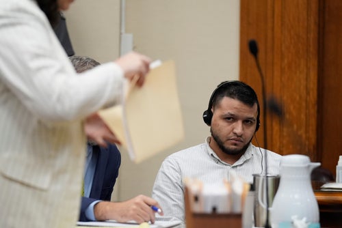 Defense attorney Kaitlyn Beck shuffles papers in a folder as Jose Ibarra, center, appears in court for a motion hearing on Oct. 11, 2024, in Athens, Georgia.