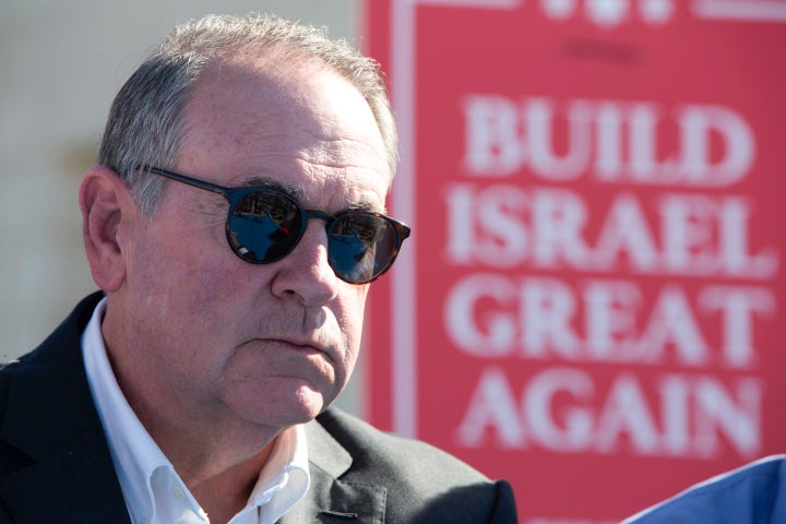 Former Arkansas Gov. Mike Huckabee takes questions from the media at a new housing complex in the West Bank settlement of Efrat on Aug. 1, 2018. 