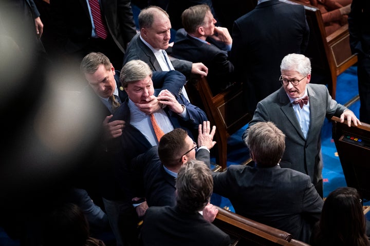 Rep. Patrick McHenry (R-N.C.), right, watches as Rep. Richard Hudson (R-N.C.), left, pulls Rep. Mike Rogers (R-Ala.), back as Rogers yells at Rep. Matt Gaetz (R-Fla.), and others during the 14th round of voting for speaker as the House meets for the fourth day to try and elect a speaker and convene the 118th Congress on Jan. 6, 2023.