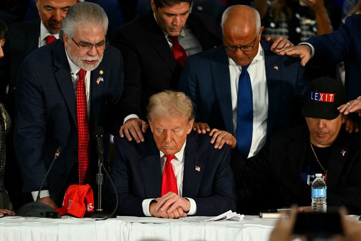 President-elect Donald Trump prays during a roundtable discussion with Latino community leaders at Trump National Doral Miami resort in Miami on Oct. 22, 2024.