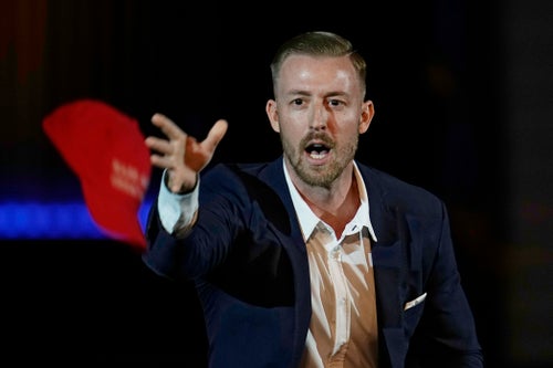 Ryan Walters, then-Republican candidate for Oklahoma State Superintendent, tosses out "Make America Great Again" ball caps at a rally on Nov. 1, 2022, in Oklahoma City. (AP Photo/Sue Ogrocki)