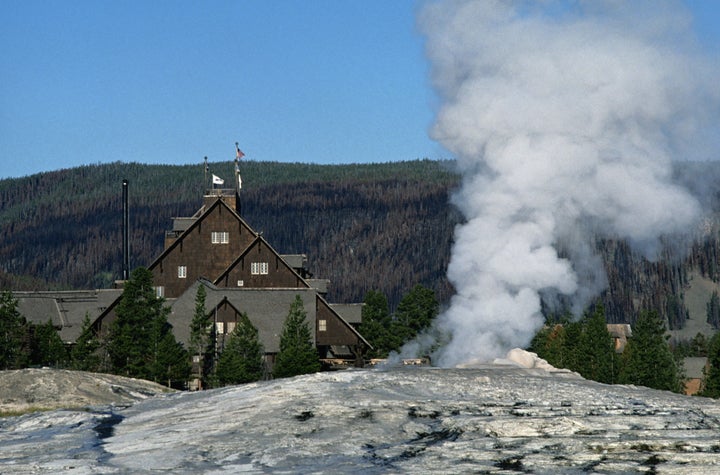 Old Faithful Inn at Yellowstone National Park is a historic hotel that offers prime views of the geyser its named for. 