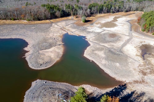 Receding waters expose the lake bed at the Ashokan Reservoir in Ulster County, New York, on Wednesday, Nov. 13, 2024. (AP Photo/Ted Shaffrey)